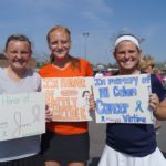 Girls hold signs