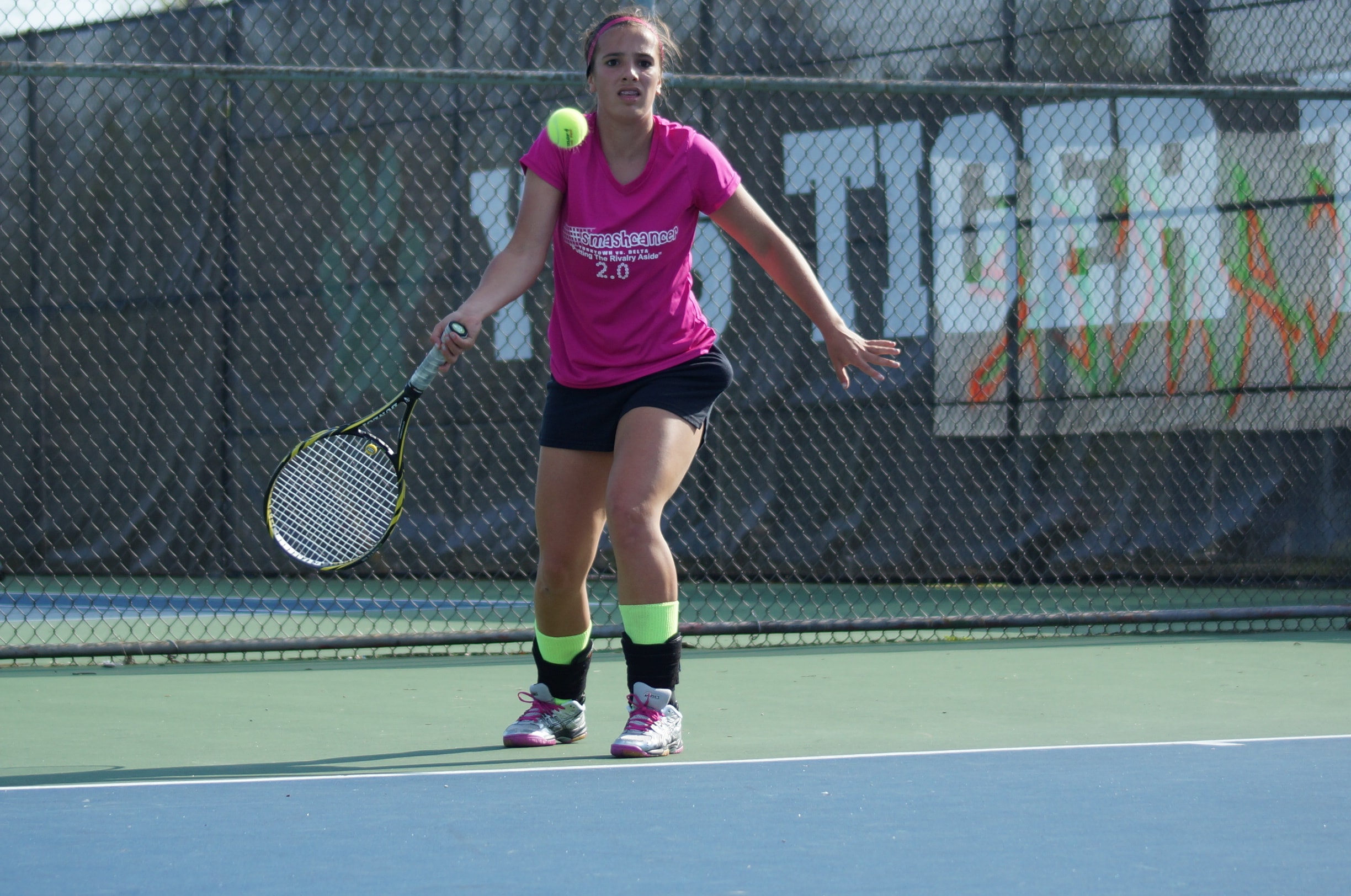 Tennis player hits forehand