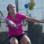 Tennis player watches ball