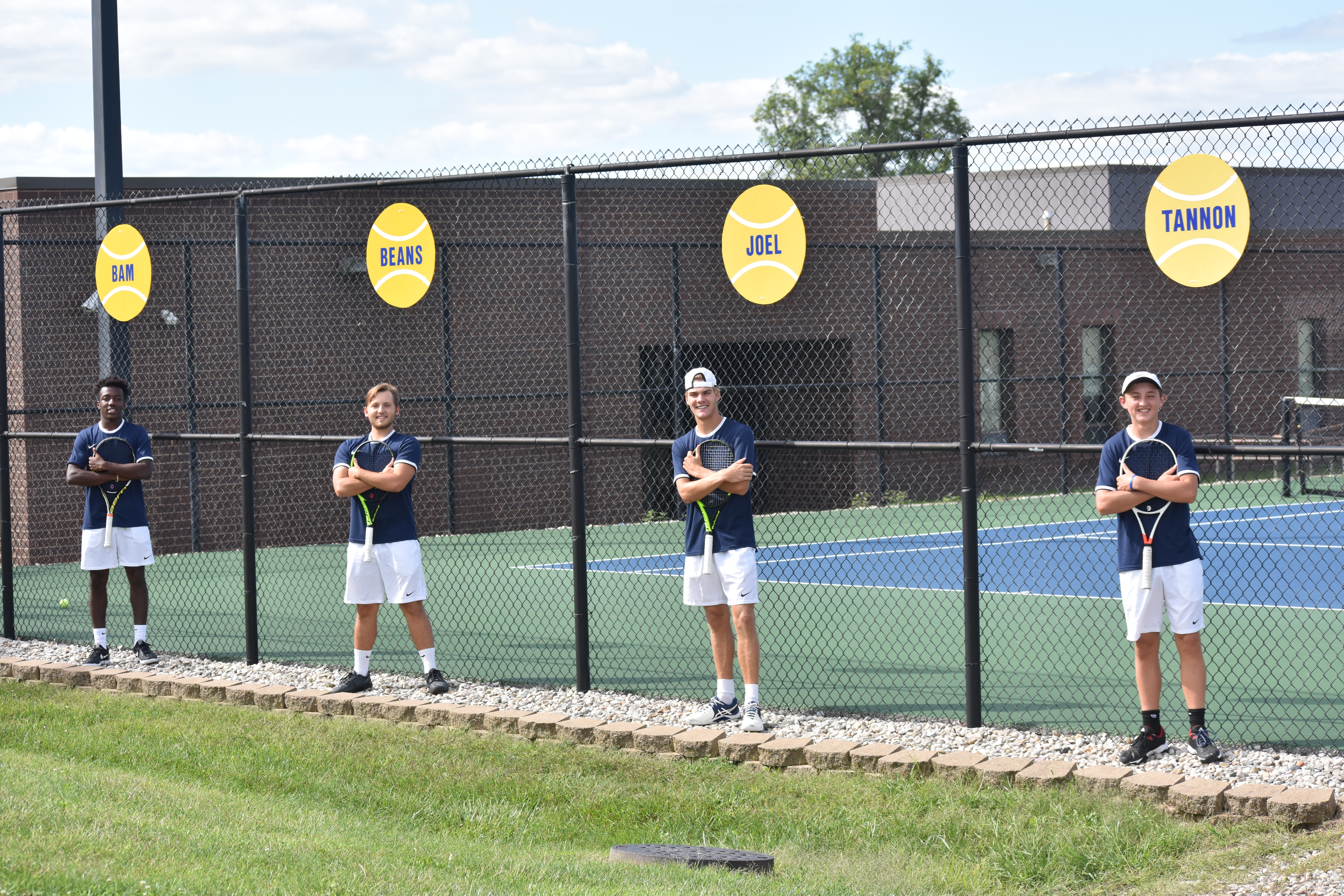Seniors stand at fence